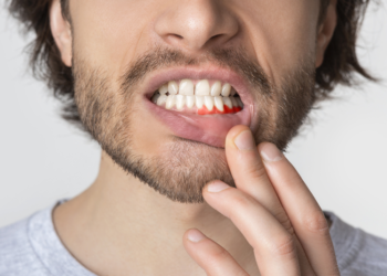 why is my gum swollen around one tooth in the back